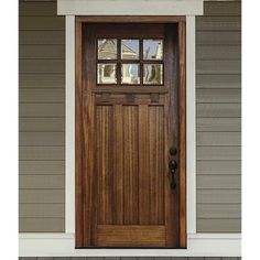 a wooden door with two sidelights on the front of a house and brick walkway