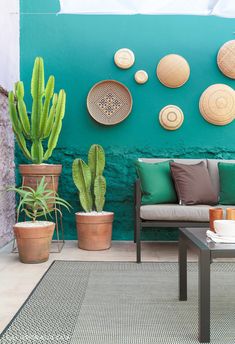 a living room filled with lots of furniture and decor on top of a green wall