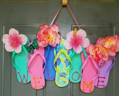 an image of a door hanger with flip flops and flowers hanging from it