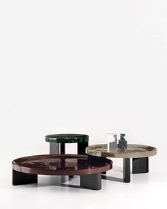 three tables with different shapes and sizes on each one table is black, brown, white and grey