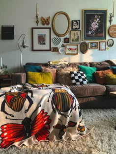 a living room filled with lots of furniture and pictures on the wall above it's couch