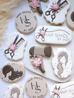 some decorated cookies with hair and scissors on top of each cookie is for someone's special day