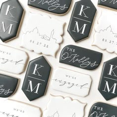 some cookies are decorated with black and white icing, which read the names of their guests