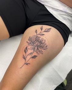 a woman with a flower tattoo on her thigh