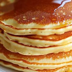 a stack of pancakes sitting on top of a white plate