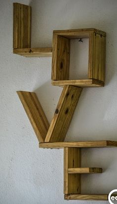 three wooden shelves are arranged on the wall