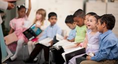 a group of children sitting next to each other