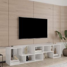 a large flat screen tv mounted to the side of a wall in a living room