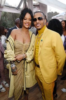 a man in a yellow suit and woman in a gold dress standing next to each other