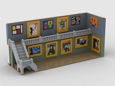 a paper model of a building with stairs and pictures on the walls