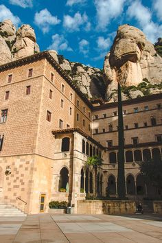 an old building with mountains in the background