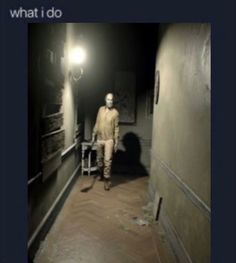 the man is walking down the hallway in the dark