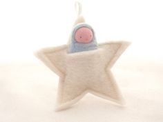 a stuffed animal in the shape of a star with a pink nose sitting on top of it