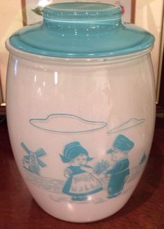 a blue and white cookie jar sitting on top of a wooden table