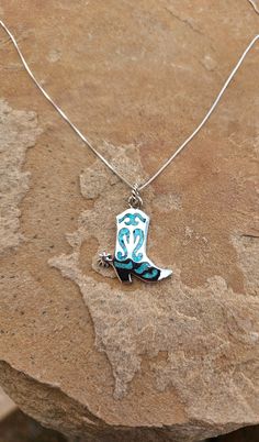 Expertly crafted with .925 sterling silver, this Dazzled in Turquoise Boot Pendant features a gorgeous turquoise chip inlay that adds a touch of vibrant color. Complete with a sturdy twenty inch chain, this pendant is the perfect accessory for any boot lover. Southern Jewelry, Turquoise Boots, Cowgirl Accessories, Cowgirl Jewelry, Kids Earrings, Western Jewelry, White Buffalo, Okra, Pink Opal