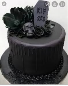 a black cake decorated with skulls and flowers