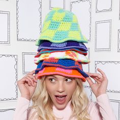 a woman wearing a multicolored crocheted hat on top of her head