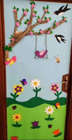 a door decorated with flowers, birds and a tree branch on it's side