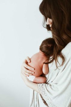 a woman holding a baby in her arms