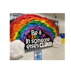 a bulletin board that has been decorated with rainbows and the words be a rainbow in someone else's cloud