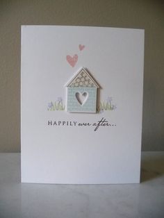 a white card with a house and heart on the front that says happily ever after