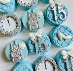 blue and white decorated cookies with clock faces on them are arranged in the shape of clocks