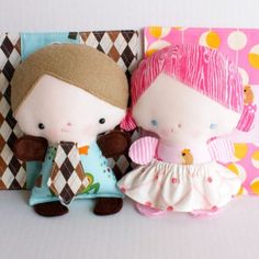 two dolls are sitting next to each other