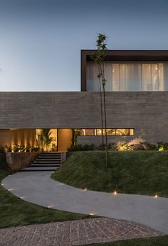 an exterior view of a modern house at dusk