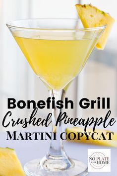 a close up of a martini in a coupe glass with pineapple garnish