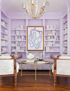 a living room filled with furniture and a chandelier