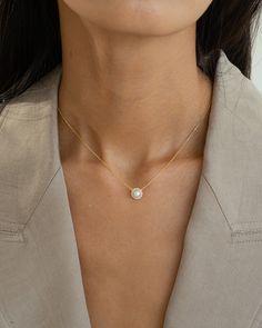 The Eleanor Pearl Necklace is a timeless symbol of sophistication. Featuring a lustrous pearl encircled by radiant accents, this exquisite piece adds elegance to any ensemble, making it a key accessory for classic allure. 18k gold over sterling silver Cubic Zirconia Approx. length: 16"-17" Our gold covering on silver is a thick layer of 18k solid gold on sterling silver meaning it will last longer. You get the look and feel of gold jewelry at a fraction of the price. Silver Meaning, Pearl Necklace Gold, Timeless Symbol, Key Accessories, Gold Pearl Necklace, Everyday Necklace, Timeless Jewelry, Solid Gold, Gold Jewelry