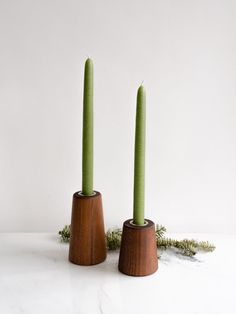 two green candles sitting on top of each other