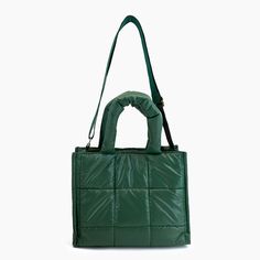 Puffer favorites are back in a plush all accessible square quilted puffer tote bag. This nylon purse is lightweight with secure closures and adjustable long strap for a crossbody option. A rich forest green colorway suitable for the holiday seasons. The perfect gift, diaper bag, work bag, or just everyday accessory to carry all your daily essentials. Composition: Nylon Dimensions: 11 1/2"W x 9 1/2"H x 5 1/2"D 6 1/2'' Top Handle 24" Adjustable/Detachable Strap Magnetic Closure 1 inner zipper pock Green Large Capacity Bags For Winter, Green Travel Bags For Winter, Green Rectangular Shoulder Bag For Winter, Green Winter Shoulder Bag, Trendy Green Bag For Winter, Winter Green Shoulder Bag, Green Winter Bags, Green Everyday Bag For Winter, Winter Quilted Tote Shoulder Bag