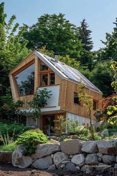 the house is surrounded by trees and rocks