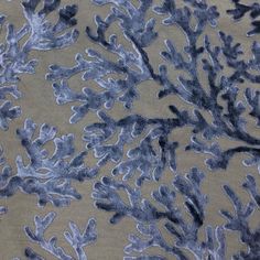 an upholstered fabric with blue and grey corals on it