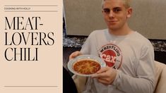 a man holding a bowl of food with the words meat lover's chili on it