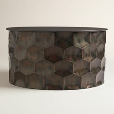 a round metal table with hexagonal tiles on it's top and bottom