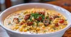 a white bowl filled with pasta and sausage