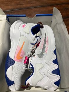 a pair of white and blue sneakers in a box