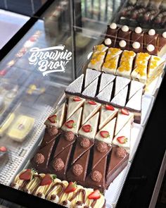 a display case filled with lots of different types of desserts