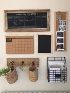 there is a bulletin board and some baskets on the wall