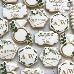 decorated cookies with names and date displayed on wooden table for guests to sign their names