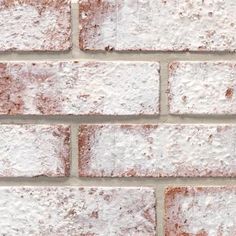 a brick wall with white and brown bricks