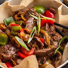 beef and peppers stir fry in a bowl with chopsticks on the side, ready to be eaten