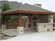 an outdoor bbq with stone walls and grilling area