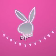 a pink background with some bunny ears hanging from it's sides and butterflies on the string