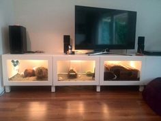 the entertainment center is built into the wall and has led lights on it, along with speakers