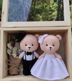 two crocheted teddy bears dressed in white and black