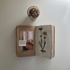 an open book with flowers on it and a bowl of ice cream in the corner