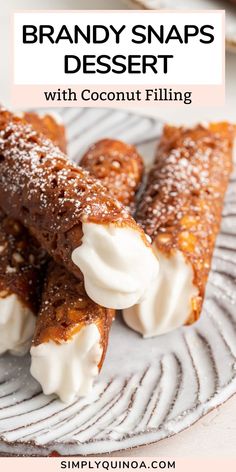 three desserts are on a plate with white icing and powdered sugar around them